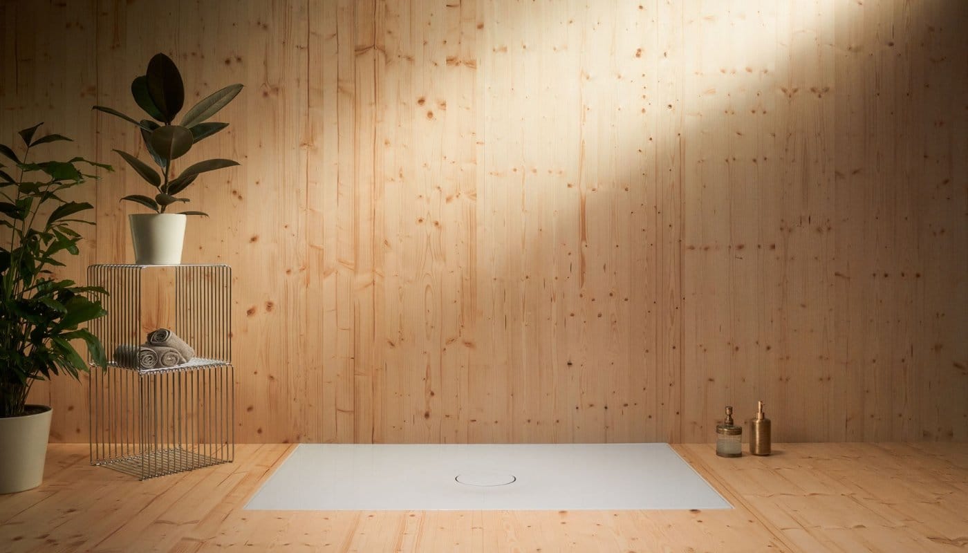 This image showcases the BetteAir shower tray with pine wood flooring.