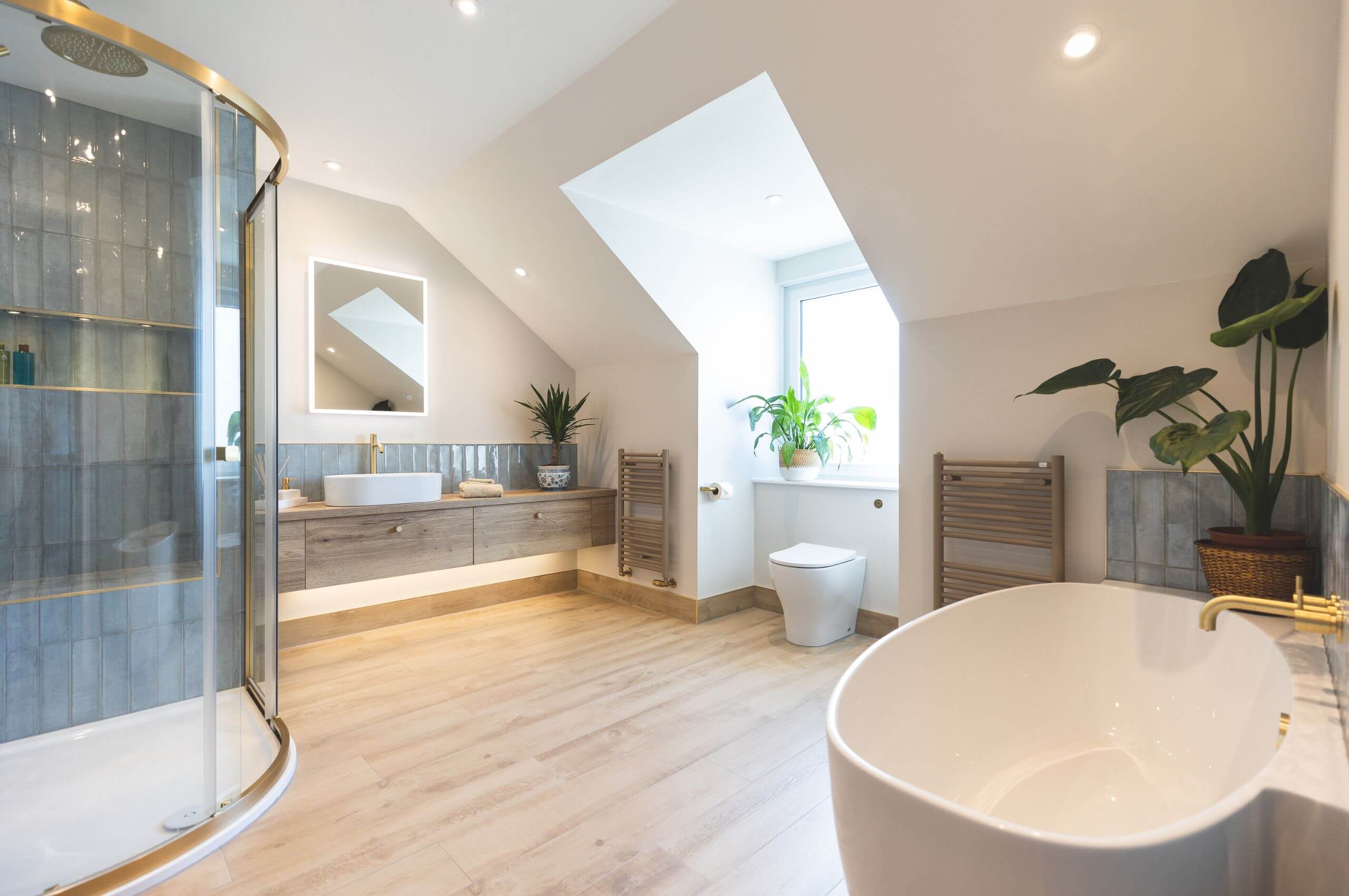 A modern bespoke bathroom renovation. A shower area and bath
