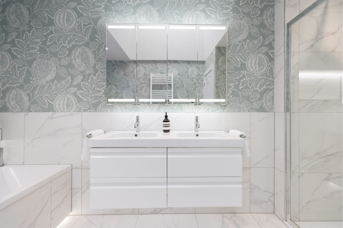 A white double vanity with a large mirror cabinet above it in a bespoke bathroom renovation in Edinburgh.